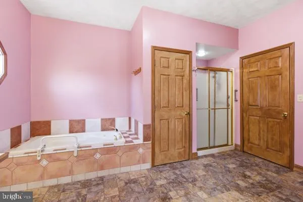 a bathroom with a tub shower and sink