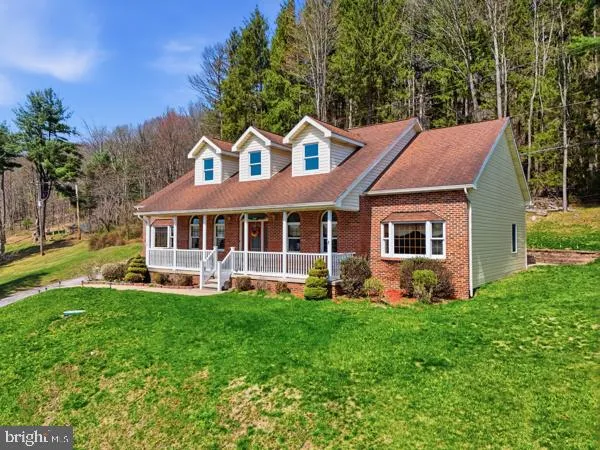a front view of house with yard and outdoor seating