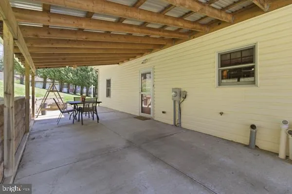 a view of a patio with table and chairs
