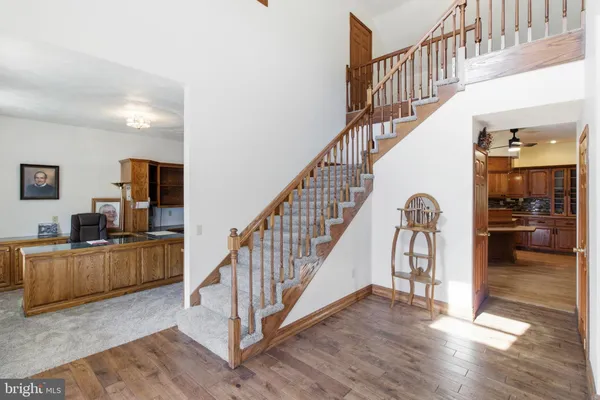a view of entryway and hall with wooden floor