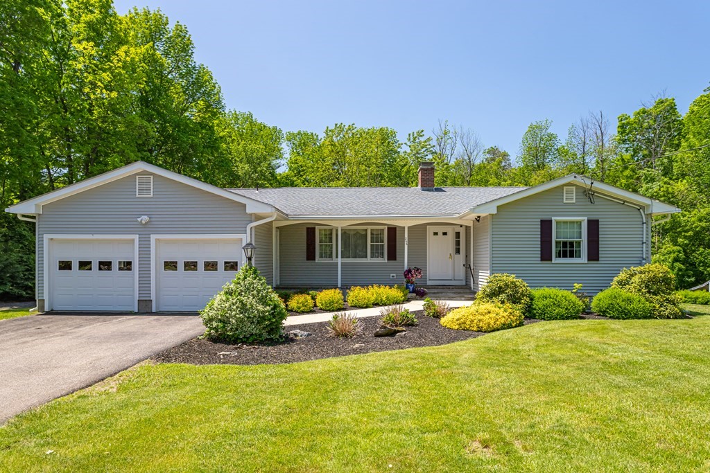 266 Worcester Road Princeton, MA 01541 - Photo 1 of 35 a front view of a house with a yard and garage