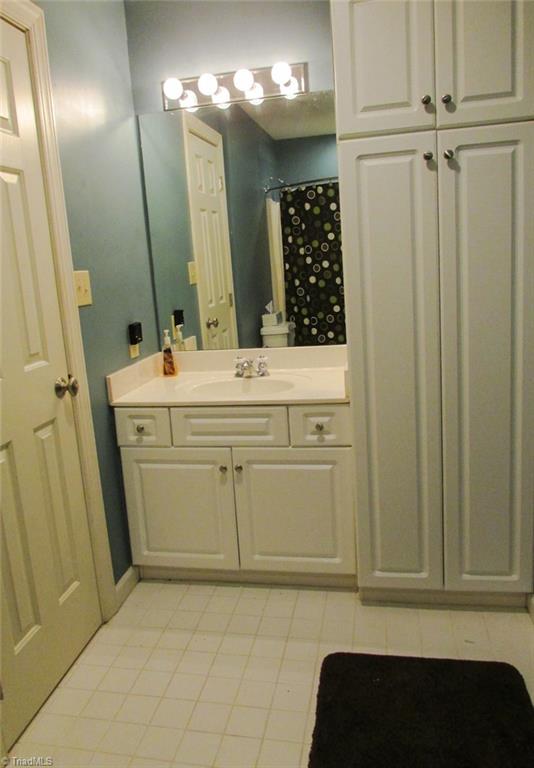 7232 Ledbetter Road Climax, NC 27233 - Photo 25 of 33 Upstairs Bathroom Features Tile Flooring, Floor to Ceiling Linen Cabinet & Tub/Shower Combination