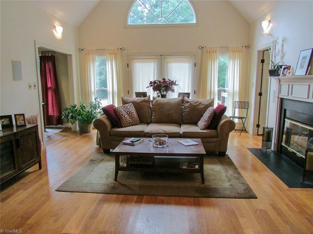7232 Ledbetter Road Climax, NC 27233 - Photo 10 of 33 The Vaulted Living Room Features Fresh Paint, Hardwood Flooring, Gas Logs Fireplace, Accent Lighting & New Ceiling Fan
