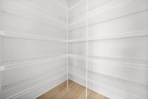 a view of walk in closet with empty racks