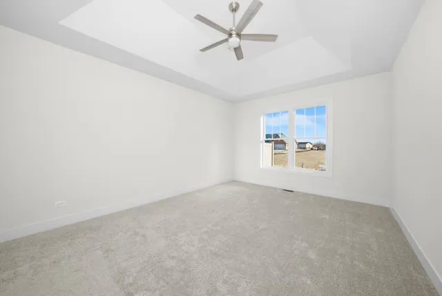 an empty room with a empty space and a ceiling fan