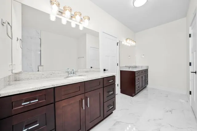 a bathroom with a sink vanity and a mirror