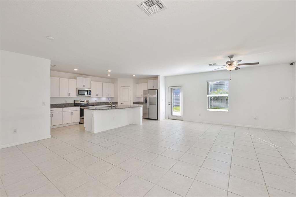 9913 Jackfruit Court Riverview, FL 33578 - Photo 11 of 57 a view of kitchen with kitchen island white cabinets and refrigerator