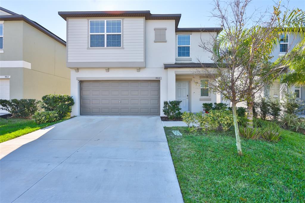 9913 Jackfruit Court Riverview, FL 33578 - Photo 2 of 57 a front view of a house with a yard and garage