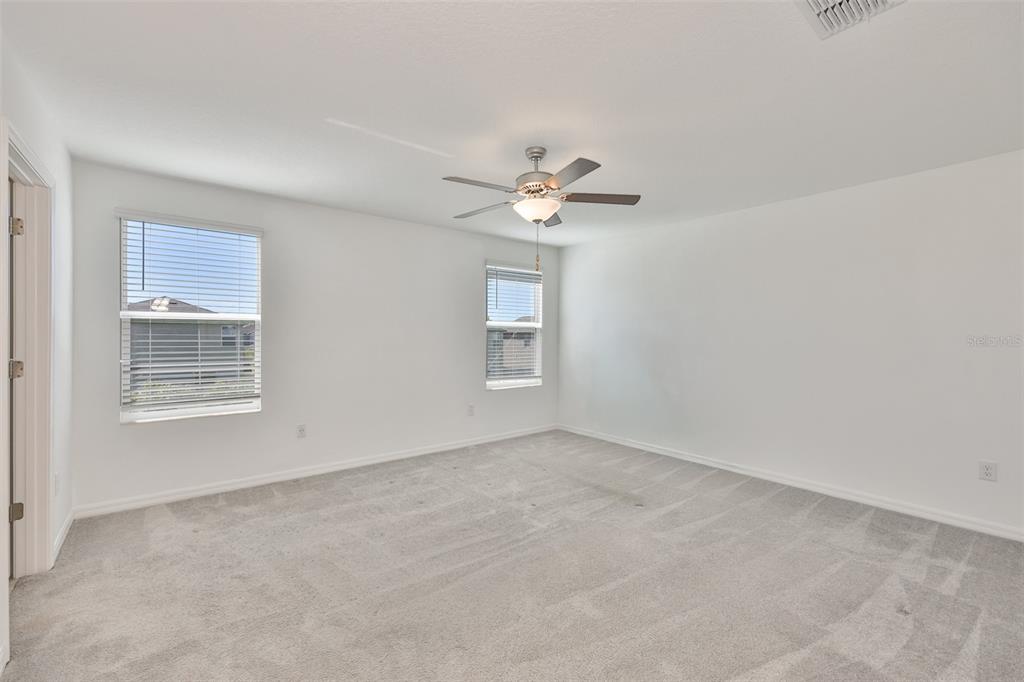 9913 Jackfruit Court Riverview, FL 33578 - Photo 25 of 57 an empty room with windows and fan