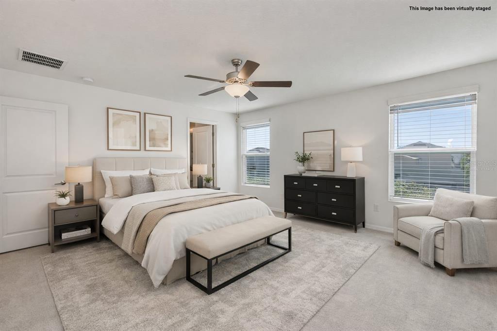 9913 Jackfruit Court Riverview, FL 33578 - Photo 28 of 57 a spacious bedroom with a bed and a couch