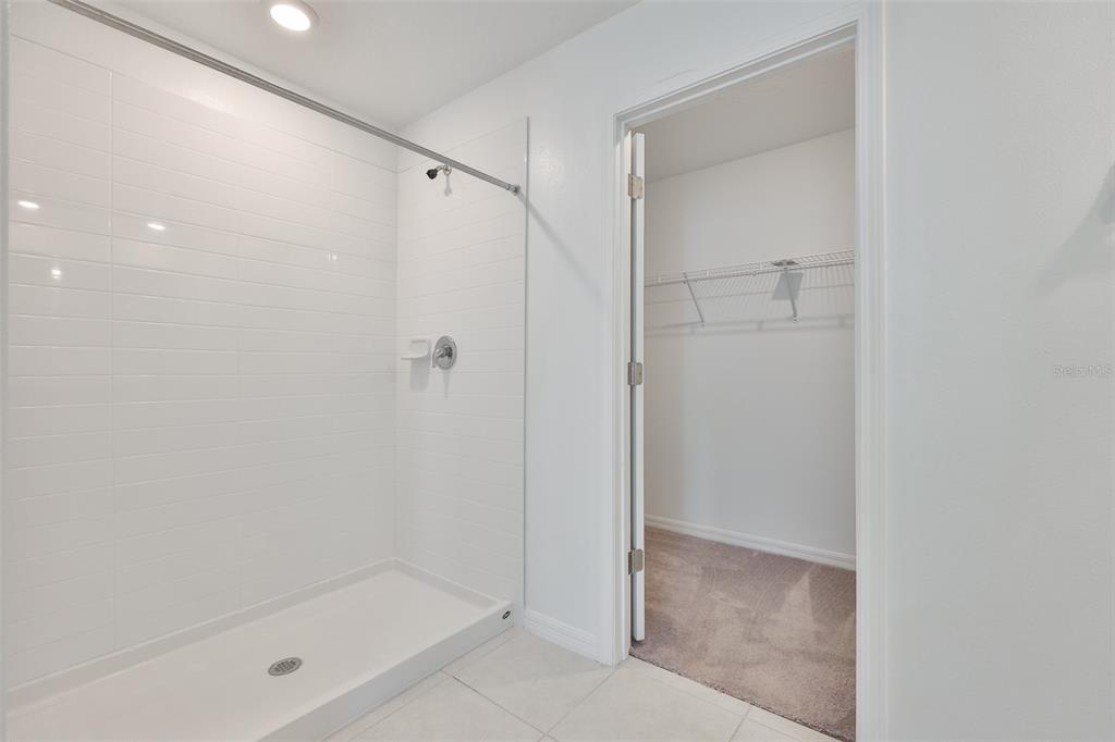 9913 Jackfruit Court Riverview, FL 33578 - Photo 30 of 57 a bathroom with a glass shower door