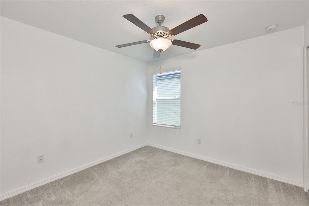 9913 Jackfruit Court Riverview, FL 33578 - Photo 32 of 57 an empty room with a ceiling fan and a window