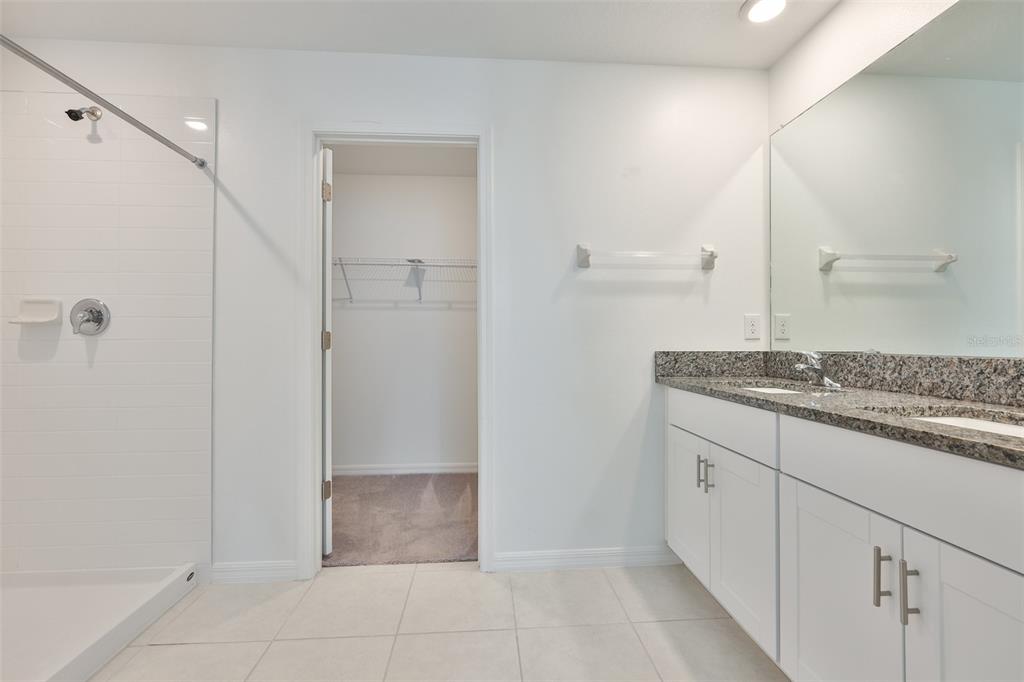 9913 Jackfruit Court Riverview, FL 33578 - Photo 34 of 57 a bathroom with a granite countertop sink and mirror