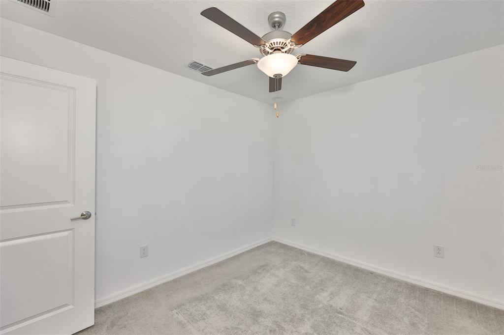 9913 Jackfruit Court Riverview, FL 33578 - Photo 38 of 57 an empty room with a window and a fan