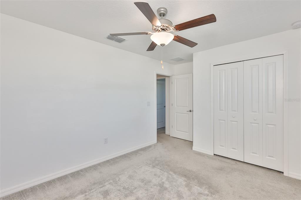 9913 Jackfruit Court Riverview, FL 33578 - Photo 39 of 57 an empty room with a ceiling fan and a window