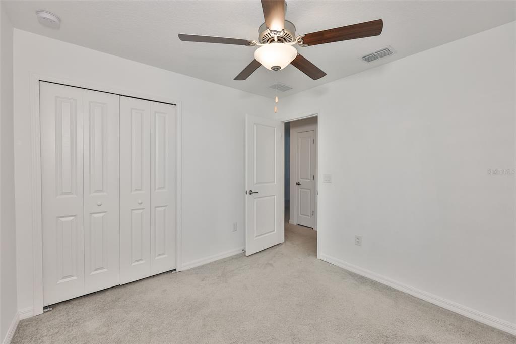 9913 Jackfruit Court Riverview, FL 33578 - Photo 44 of 57 an empty room with chandelier fan
