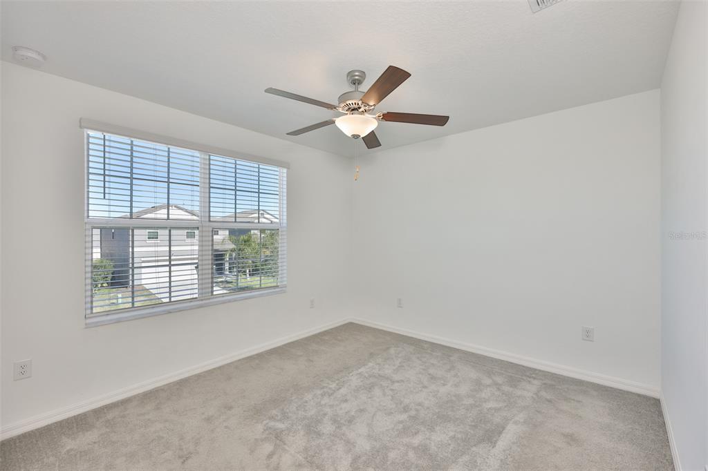 9913 Jackfruit Court Riverview, FL 33578 - Photo 46 of 57 an empty room with a window and a fan