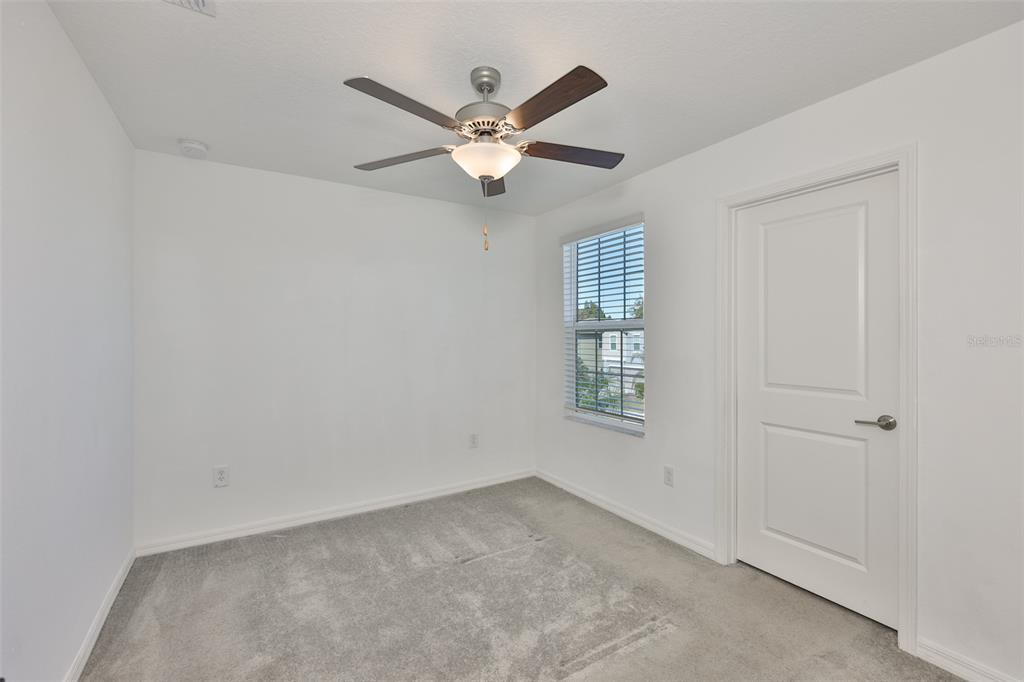 9913 Jackfruit Court Riverview, FL 33578 - Photo 47 of 57 an empty room with windows and fan