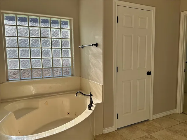 a bath tub sitting next to a window