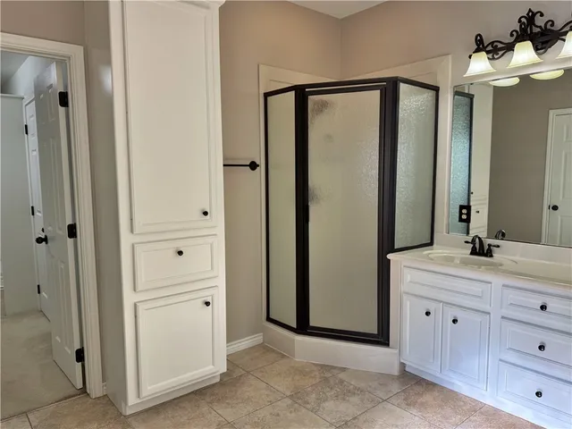 a spacious bathroom with a mirror sink and mirror