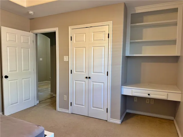 a view of an empty room with cabinet