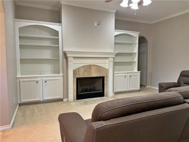 a living room with furniture and a fireplace