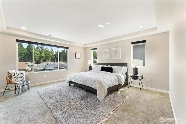 a spacious bedroom with a large bed and a large window