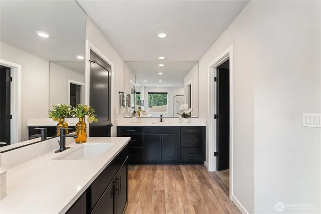 a large kitchen with a sink and refrigerator
