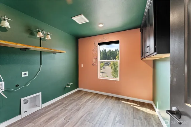 a view of room with window and wooden floor