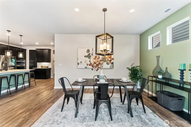 a view of a dining room with furniture window and wooden floor