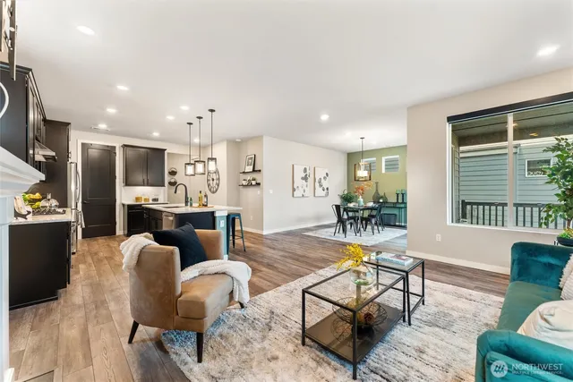 a living room with furniture and kitchen view