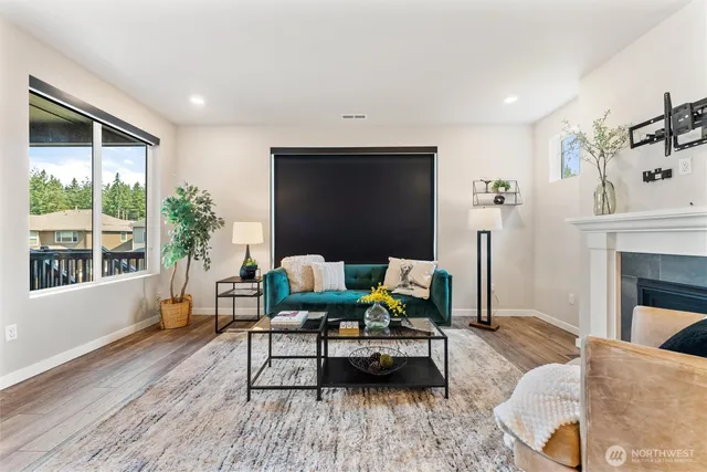 a living room with furniture a window and a fireplace