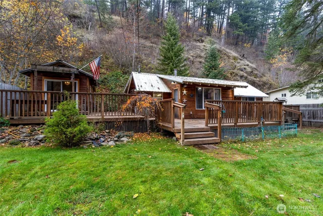 a view of a house with a yard and sitting area