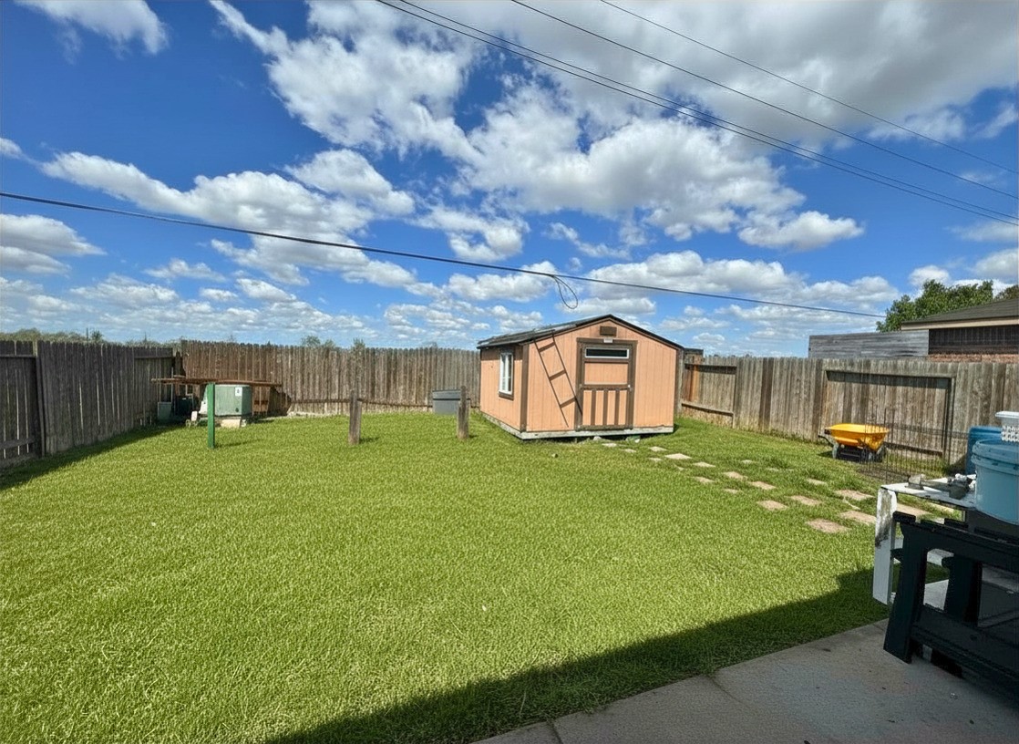 1835 Garnet Breeze Drive Rosharon, TX 77583 - Photo 17 of 19 a view of a backyard with table and chairs and wooden fence