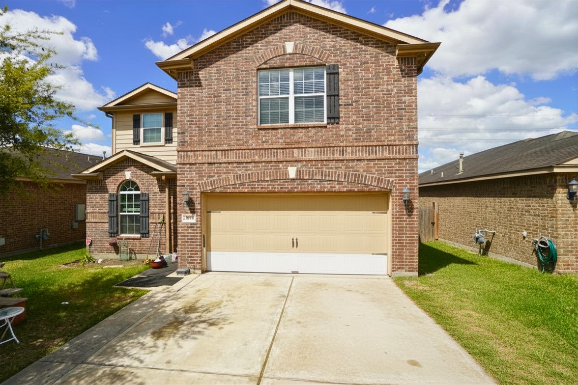 1835 Garnet Breeze Drive Rosharon, TX 77583 - Photo 2 of 19 a front view of a house with a yard and garage