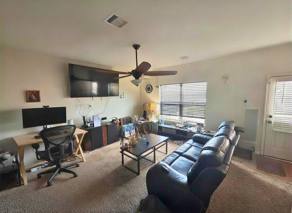 1835 Garnet Breeze Drive Rosharon, TX 77583 - Photo 6 of 19 a living room with furniture a flat screen tv and a window