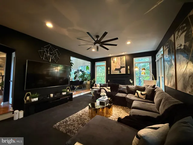 a kitchen with stainless steel appliances granite countertop a stove a sink dishwasher and a dining table with wooden floor