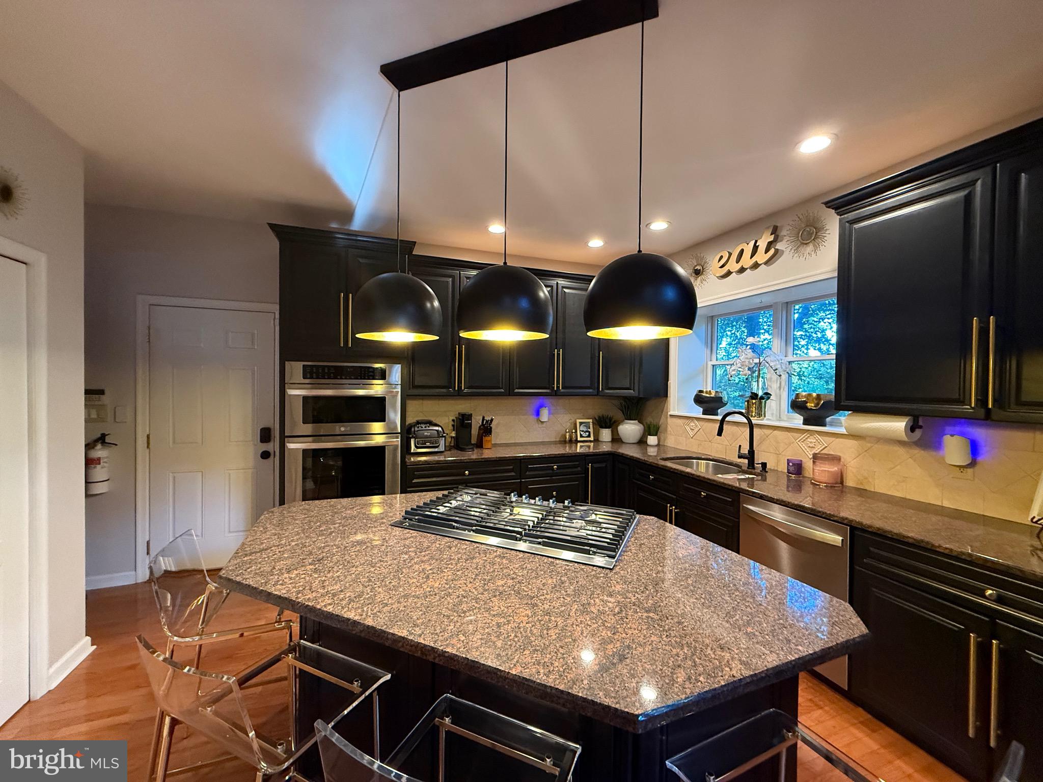 155 Erica Court Swedesboro, NJ 08085 - Photo 14 of 55 a kitchen with stainless steel appliances granite countertop a stove a refrigerator and a wooden cabinets