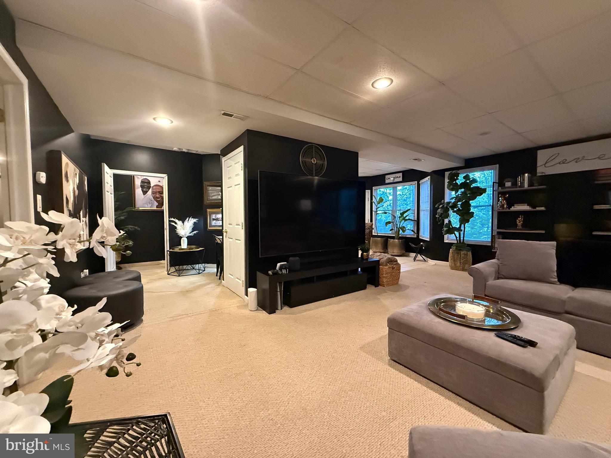 155 Erica Court Swedesboro, NJ 08085 - Photo 40 of 55 a living room with furniture and a flat screen tv
