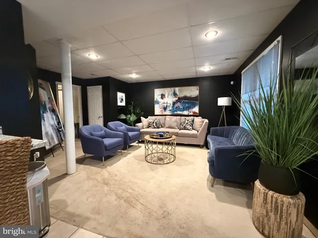 a view of a black and white dining room with a large window
