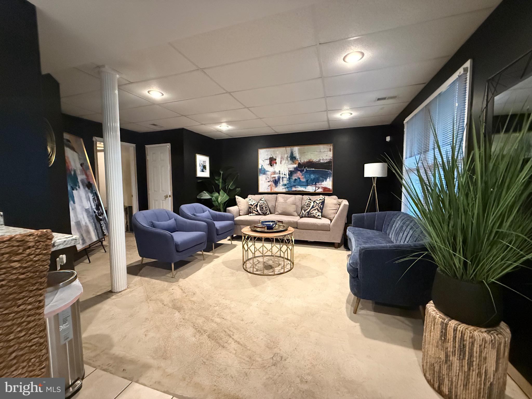 155 Erica Court Swedesboro, NJ 08085 - Photo 48 of 55 a living room with furniture a bookshelf and a potted plant