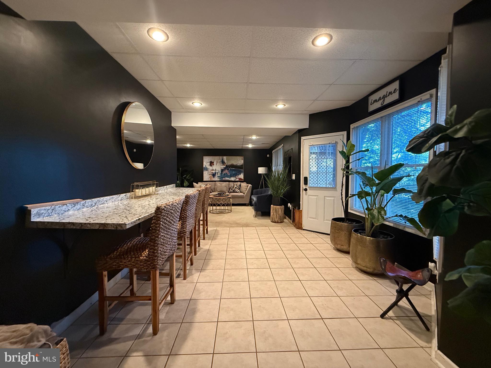 155 Erica Court Swedesboro, NJ 08085 - Photo 50 of 55 a open kitchen with stainless steel appliances kitchen island granite countertop a sink a stove a dining table and chairs with wooden floor