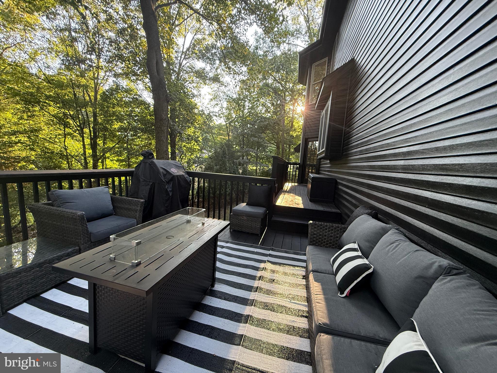 155 Erica Court Swedesboro, NJ 08085 - Photo 53 of 55 a view of a patio with couches table and chairs and potted plants