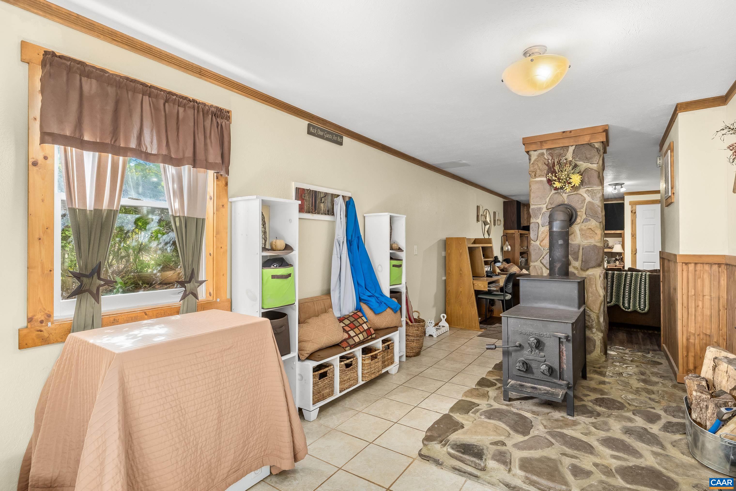 89 Fox Hollow Road Ruckersville, VA 22968 - Photo 21 of 37 a living room with furniture a large window and a chandelier