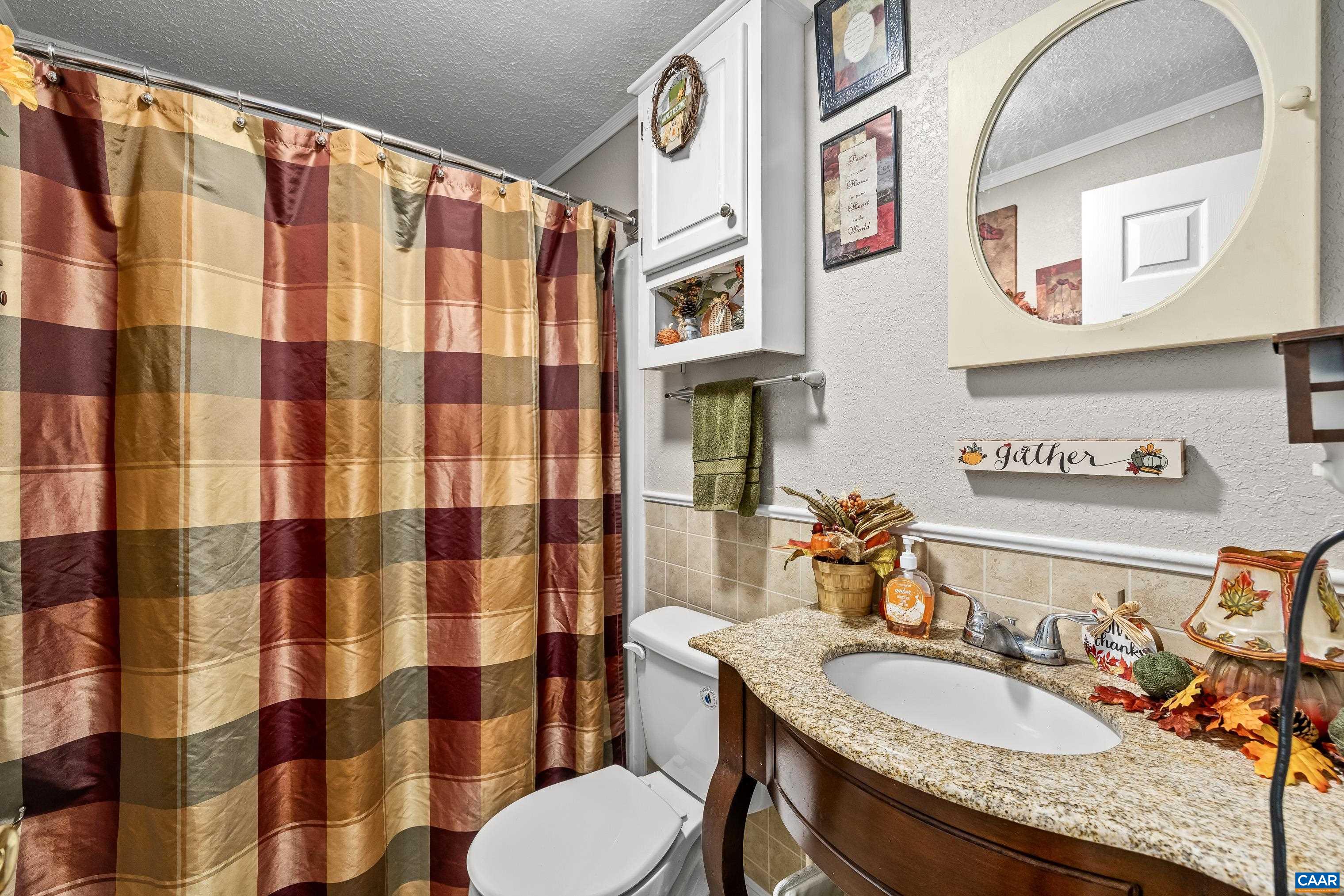 89 Fox Hollow Road Ruckersville, VA 22968 - Photo 28 of 37 a bathroom with a granite countertop sink and a mirror