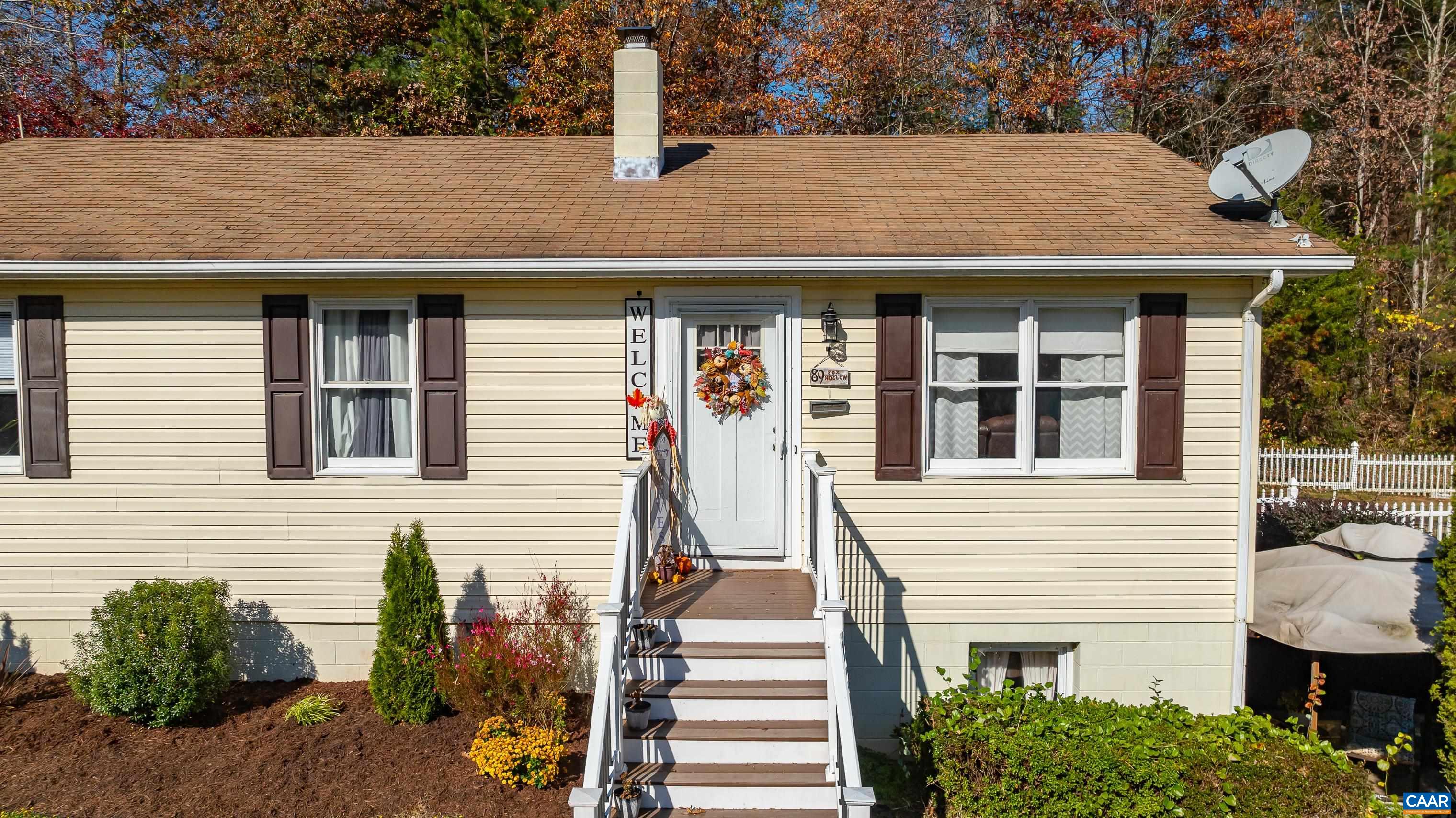 89 Fox Hollow Road Ruckersville, VA 22968 - Photo 5 of 37 a front view of a house with a yard and potted plants