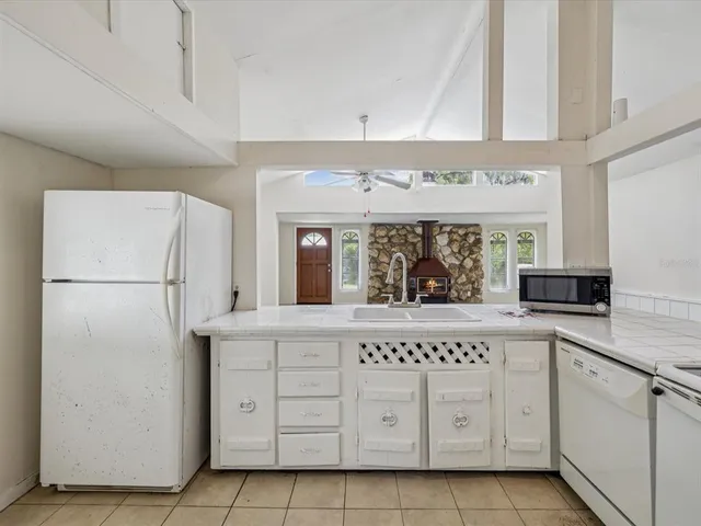 a kitchen with cabinets stainless steel appliances and a counter space