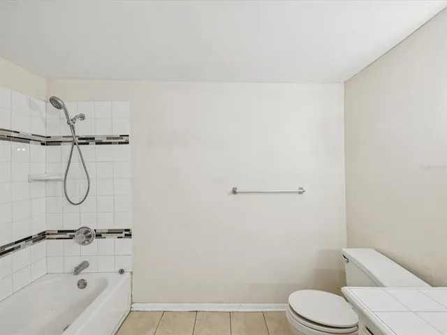 a bathroom with a shower and toilet