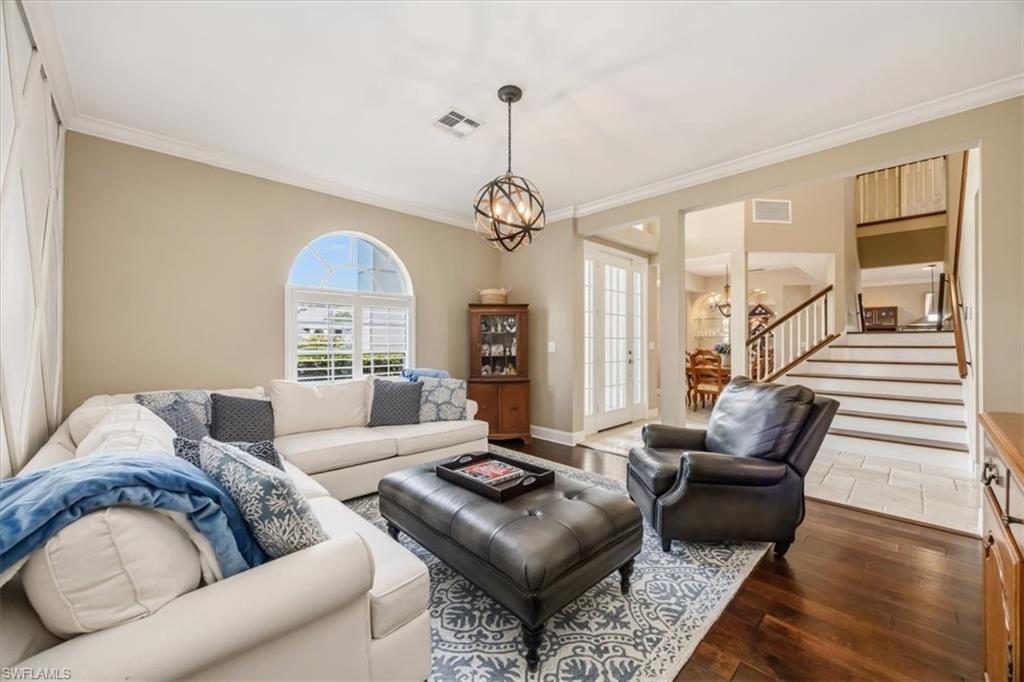 2066 Imperial Circle Naples, FL 34110 - Photo 12 of 29 a living room with furniture and a chandelier