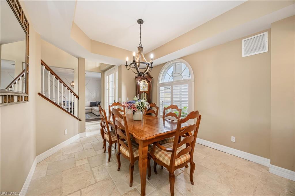 2066 Imperial Circle Naples, FL 34110 - Photo 13 of 29 a view of a dining room with furniture and a chandelier